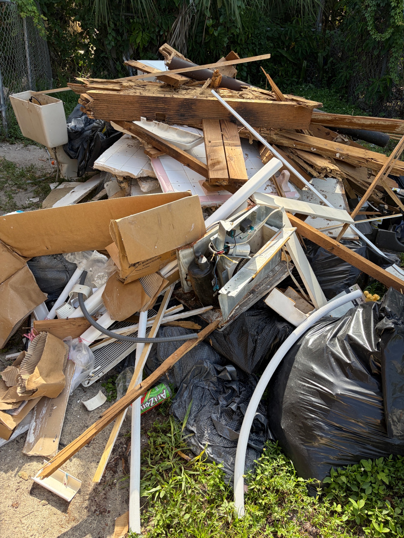 South Florida construction debris removal pile with lumber, drywall, and renovation waste cleared by Fresh Start Junk Removal