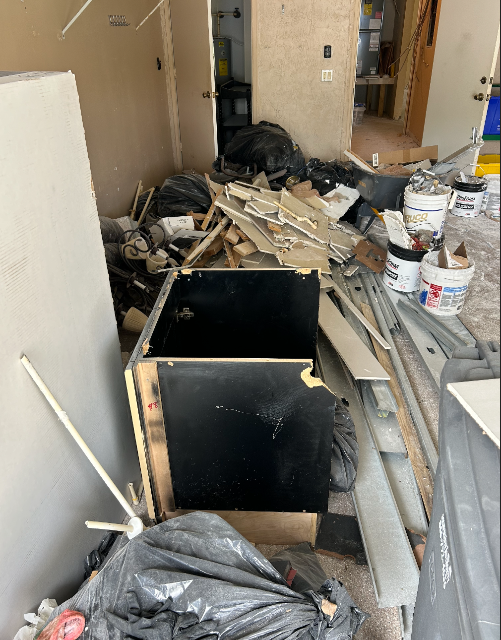 Interior demolition of kitchen and bathroom with debris ready for haul-away in South Florida