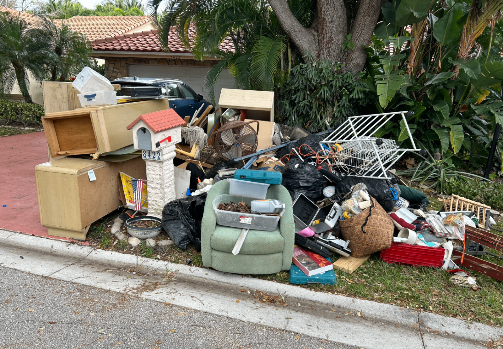 Foreclosure and eviction cleanout pile at the curb in Boynton Beach, Florida